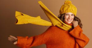 A woman happy about her dry cleaned scarf.