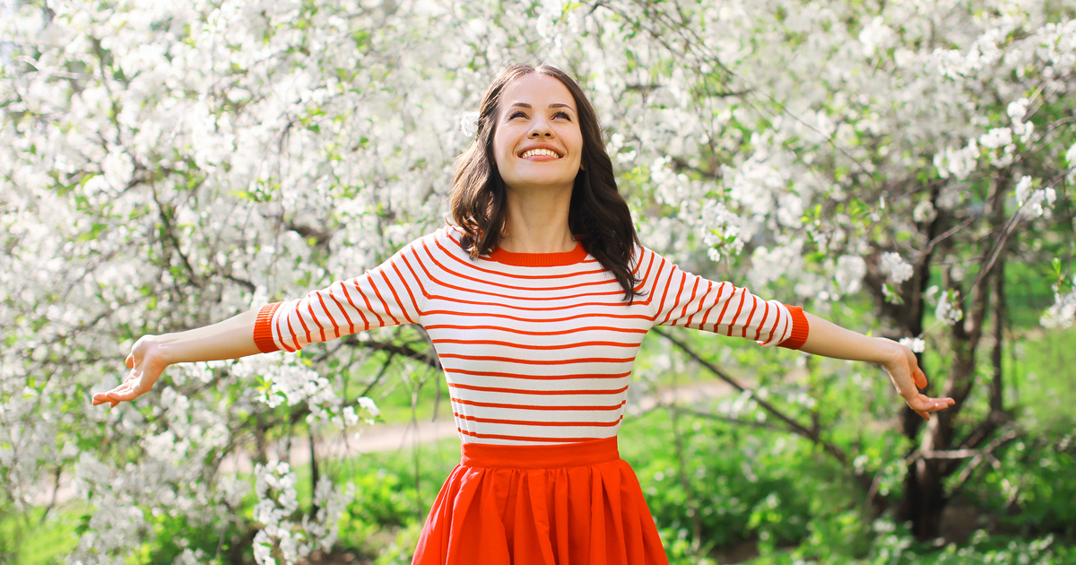 Woman wearing dress in spring field.